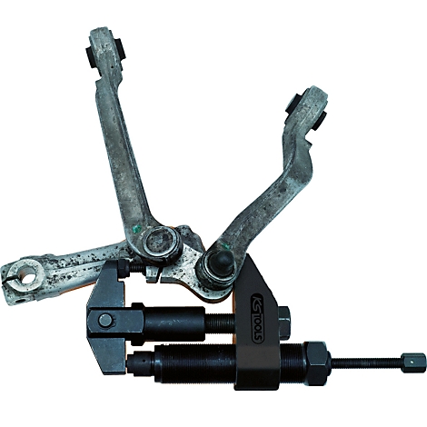 Ein Werkzeug misst an einem Metallteil. Das Werkzeug ist schwarz, das Teil ist grau.